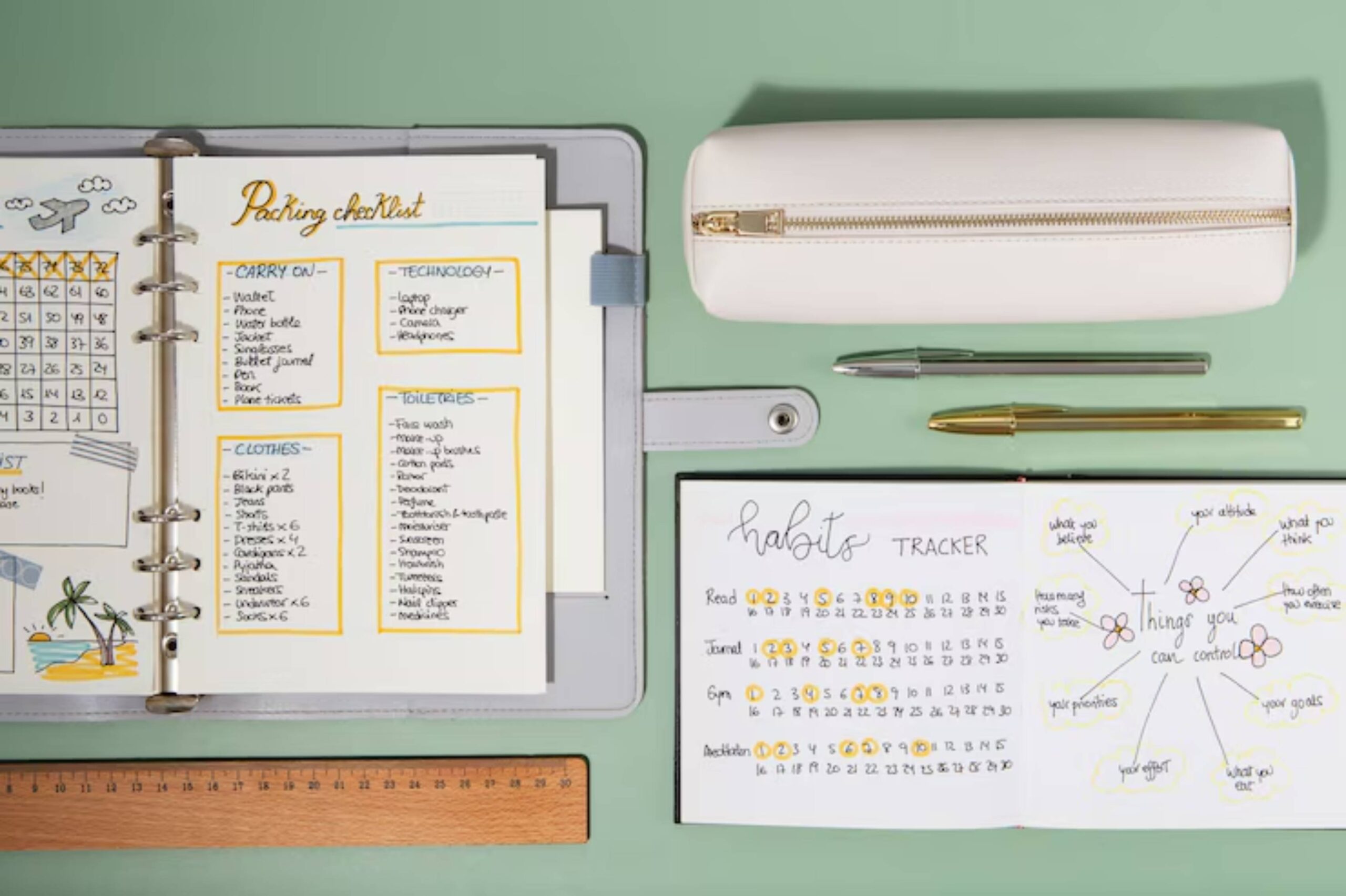 A planning setup featuring a packing checklist, habit tracker, pens, and a pencil case on a green background.